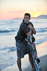 Image showing Portrait of a young  kitsurf  man at beach on sunset