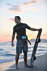 Image showing Portrait of a young  kitsurf  man at beach on sunset