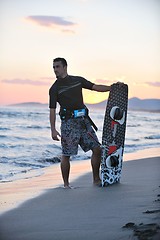 Image showing Portrait of a young  kitsurf  man at beach on sunset