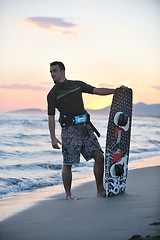 Image showing Portrait of a young  kitsurf  man at beach on sunset