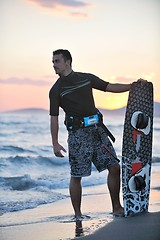 Image showing Portrait of a young  kitsurf  man at beach on sunset