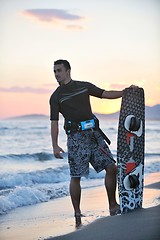 Image showing Portrait of a young  kitsurf  man at beach on sunset