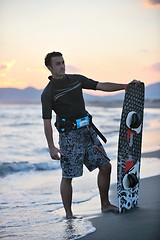 Image showing Portrait of a young  kitsurf  man at beach on sunset