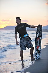 Image showing Portrait of a young  kitsurf  man at beach on sunset