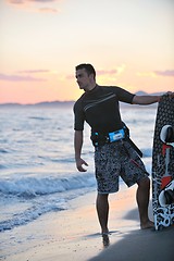 Image showing Portrait of a young  kitsurf  man at beach on sunset