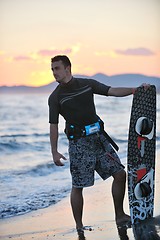 Image showing Portrait of a young  kitsurf  man at beach on sunset