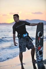 Image showing Portrait of a young  kitsurf  man at beach on sunset