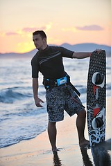 Image showing Portrait of a young  kitsurf  man at beach on sunset