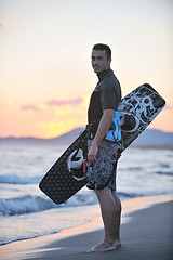 Image showing Portrait of a young  kitsurf  man at beach on sunset