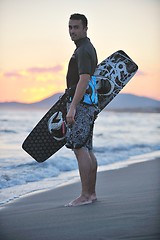 Image showing Portrait of a young  kitsurf  man at beach on sunset