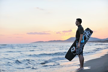 Image showing Portrait of a young  kitsurf  man at beach on sunset