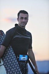 Image showing Portrait of a young  kitsurf  man at beach on sunset