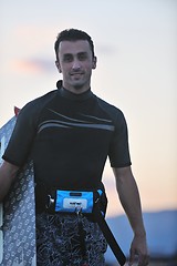 Image showing Portrait of a young  kitsurf  man at beach on sunset