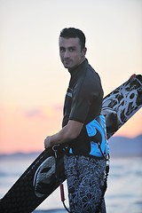 Image showing Portrait of a young  kitsurf  man at beach on sunset