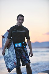 Image showing Portrait of a young  kitsurf  man at beach on sunset