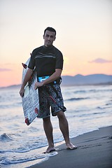 Image showing Portrait of a young  kitsurf  man at beach on sunset