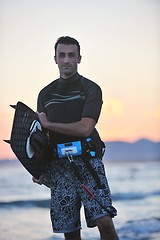 Image showing Portrait of a young  kitsurf  man at beach on sunset