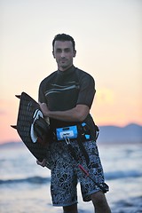 Image showing Portrait of a young  kitsurf  man at beach on sunset