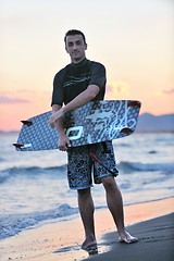 Image showing Portrait of a young  kitsurf  man at beach on sunset