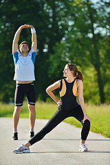Image showing people doing stretching exercise  after jogging