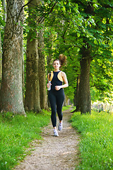 Image showing Young beautiful  woman jogging at morning in park