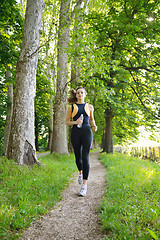 Image showing Young beautiful  woman jogging at morning in park