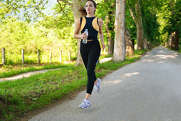 Image showing Young beautiful  woman jogging at morning in park