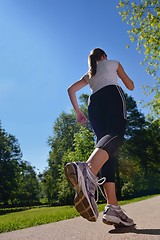 Image showing Young beautiful  woman jogging at morning in park