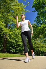 Image showing Young beautiful  woman jogging at morning in park