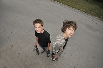 Image showing two skate boarders - top view perspective