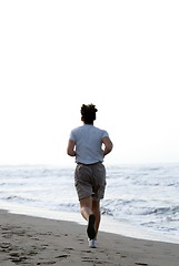 Image showing man running on beach