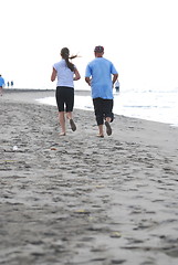 Image showing couple running on beach