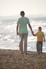 Image showing father and son walking on beach