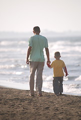 Image showing father and son walking on beach