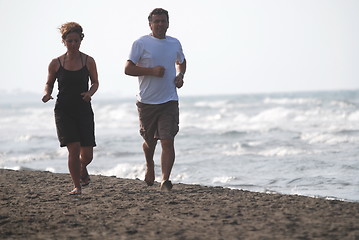 Image showing couple running on beach