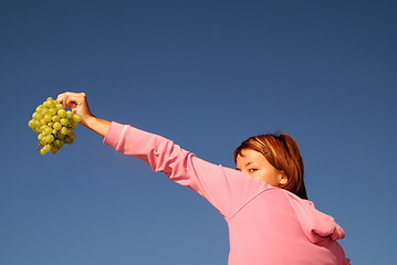 Image showing girl with grape outdoor