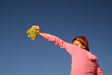 Image showing girl with grape outdoor