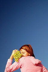 Image showing girl with grape outdoor