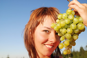 Image showing girl with grape outdoor