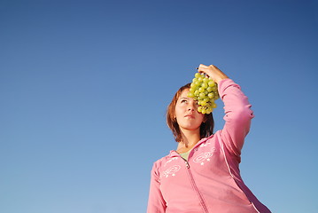 Image showing girl with grape outdoor