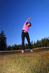 Image showing pretty girl jumping in a air 