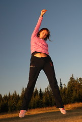 Image showing pretty girl jumping in a air 