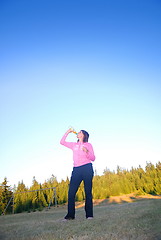 Image showing young woman drinking water