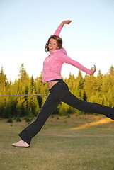 Image showing pretty girl jumping in a air 