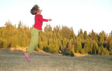 Image showing Jumping in to air