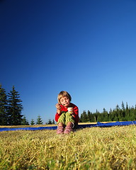 Image showing cute little girl eating healthy food outdoor