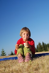 Image showing cute little girl eating healthy food outdoor