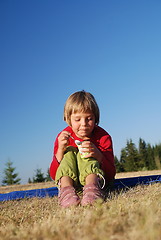 Image showing cute little girl eating healthy food outdoor