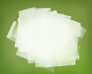 Image showing White paint. Brushstrokes on green wall.