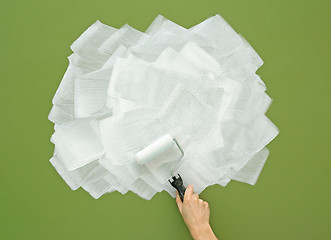 Image showing Painting green wall in white color with paint roller